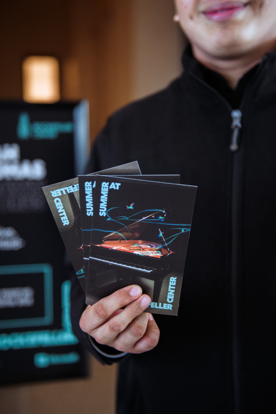 Staff member holding Dawn Chorus brochures