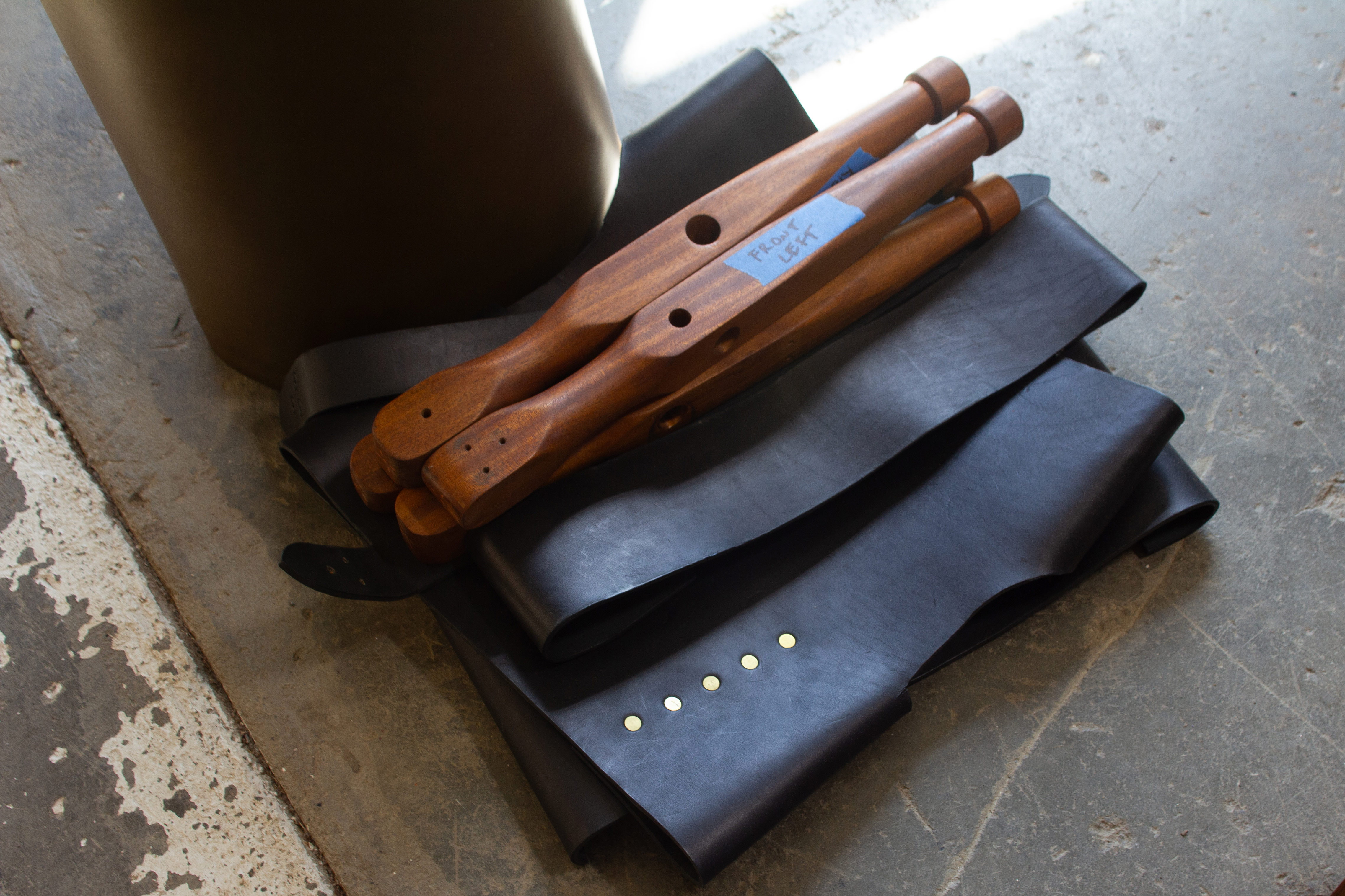 Campaign chair components: wood legs and leather straps